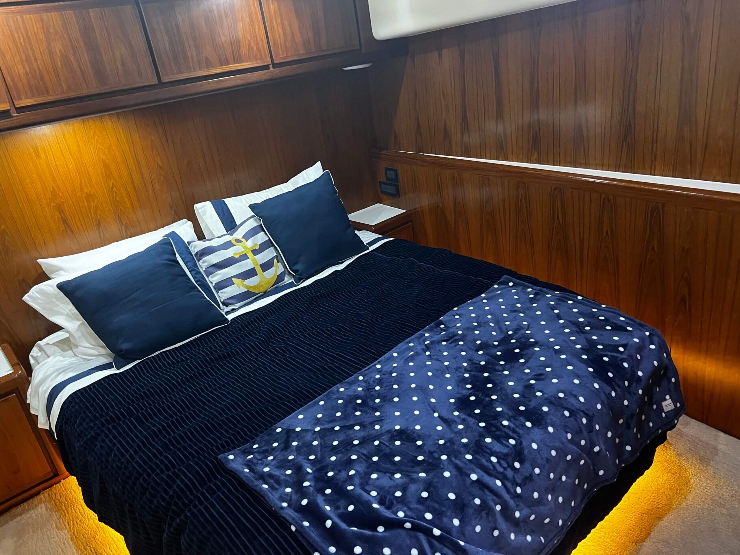 Nautical-themed bed with anchor pillow.