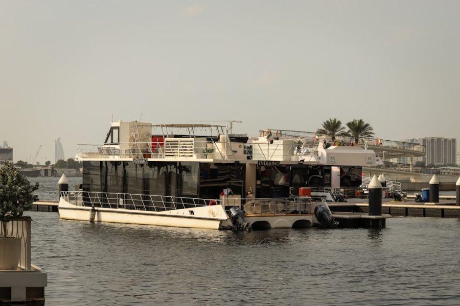 Large white riverboat docked at marina.