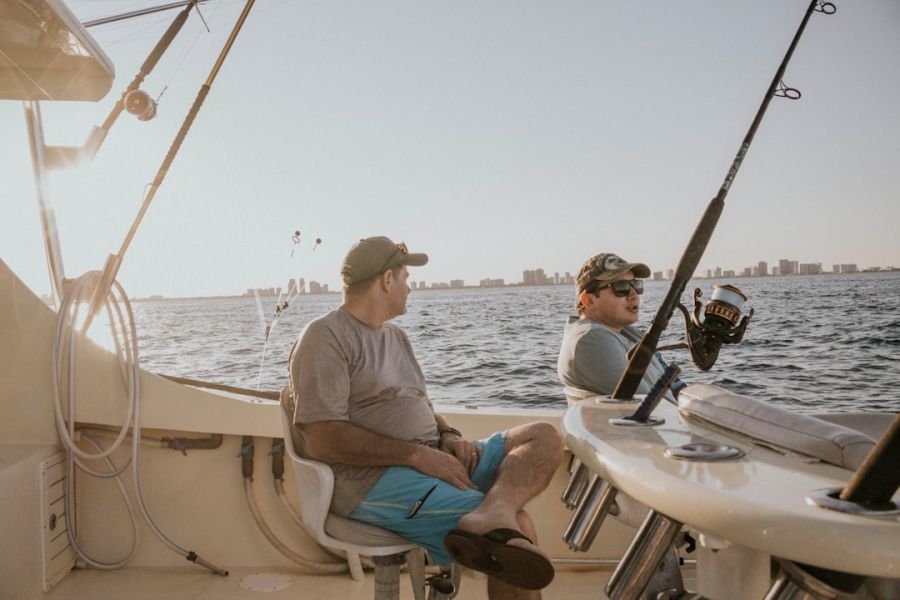 Two men fishing on a boat.