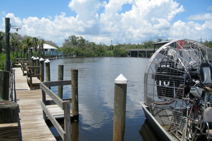 Wooden dock along calm water with boat