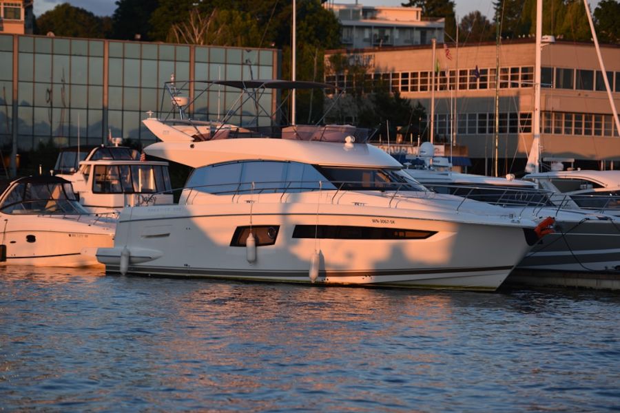 White motor yacht moored at sunset marina