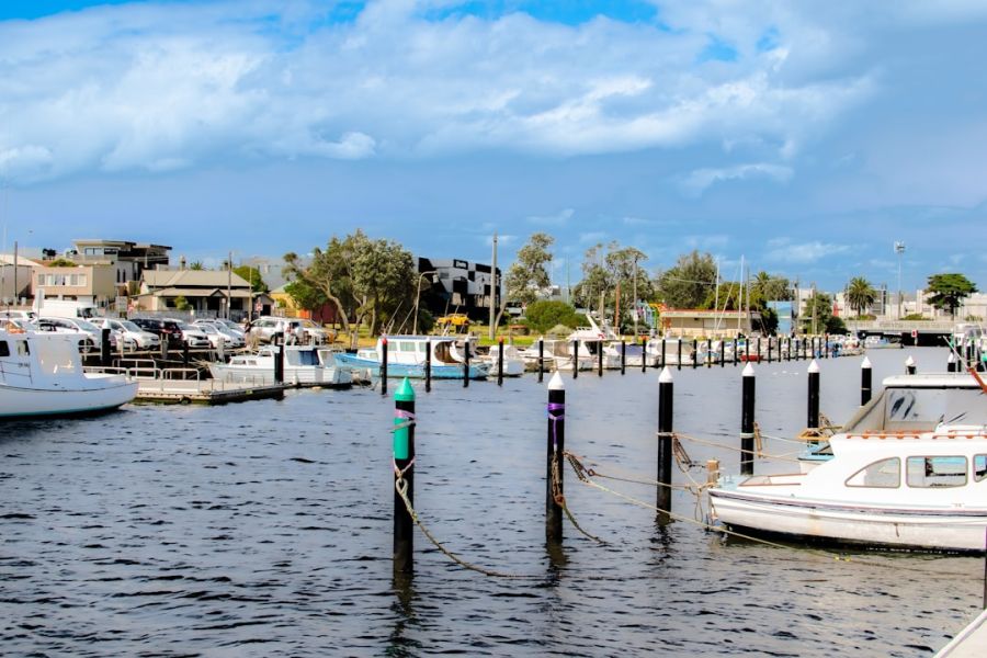 Sunny marina with moored boats and posts