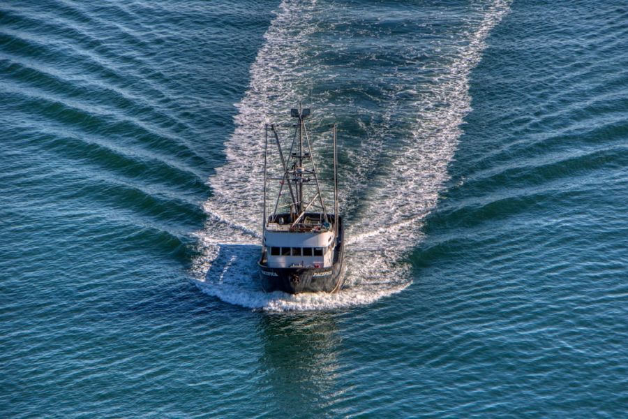 Aerial view of fishing boat on blue sea