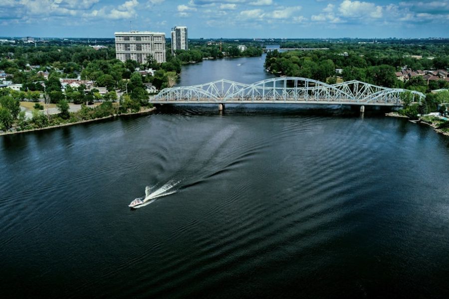 Speedboat on river under steel bridge