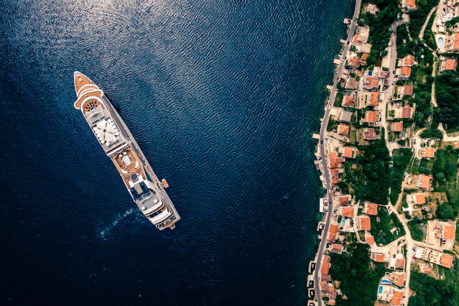 Aerial view of yacht beside coastal town