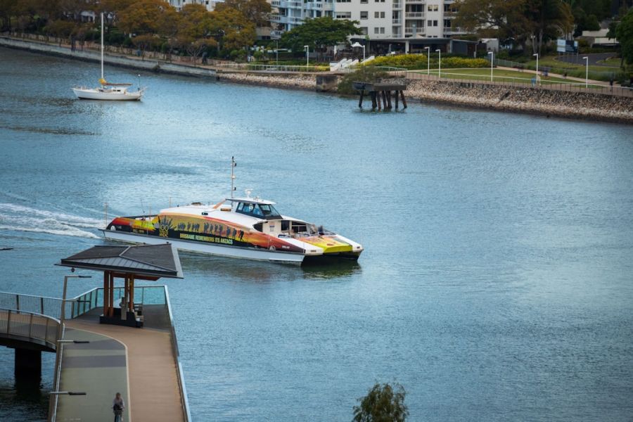 Colorful passenger ferry on calm river.