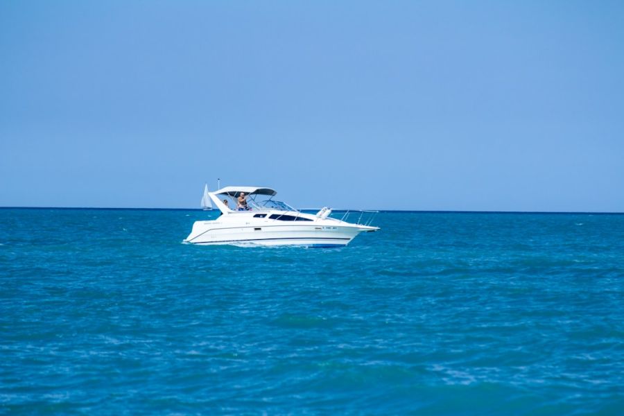 White motorboat cruising on calm blue sea