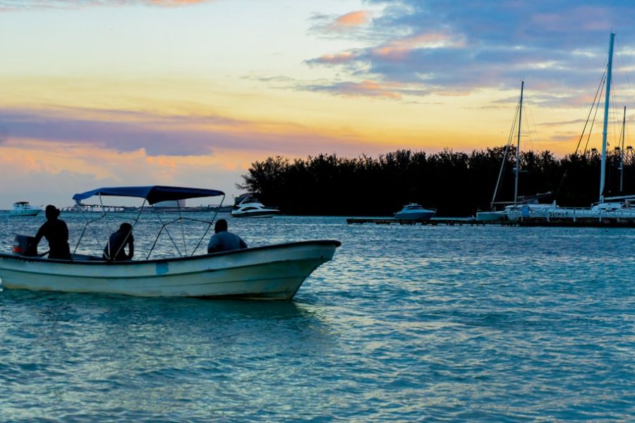 Small motorboat on sunset water