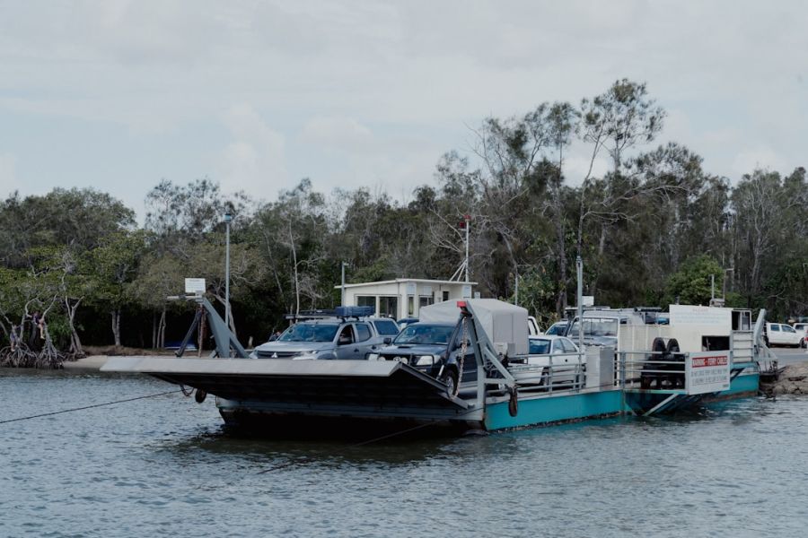 Car ferry loaded with vehicles on water.
