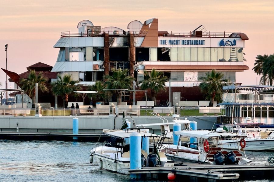 Damaged waterfront building labeled The Yacht Restaurant
