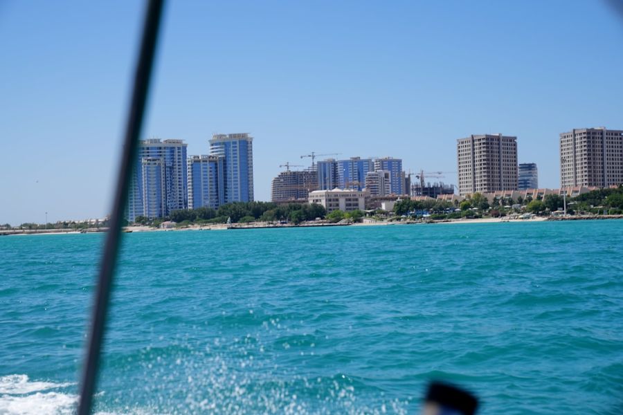 City skyline along turquoise water.
