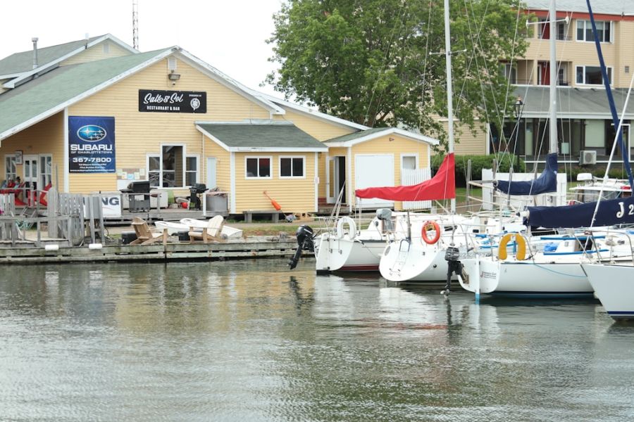 Yellow waterfront building by marina with boats.
