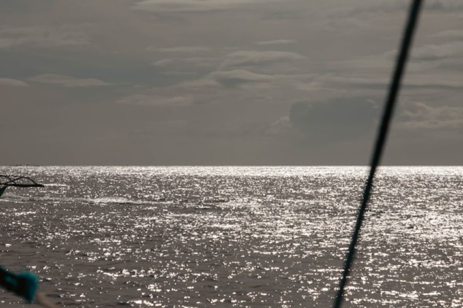 Small outrigger boat on sparkling sea