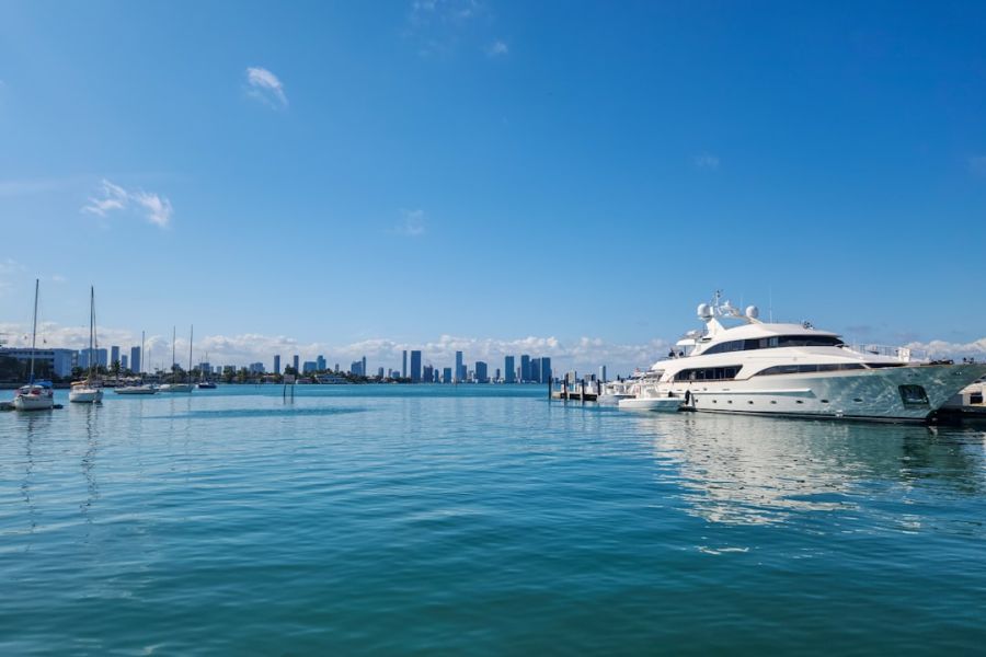 Large yacht docked at marina with skyline