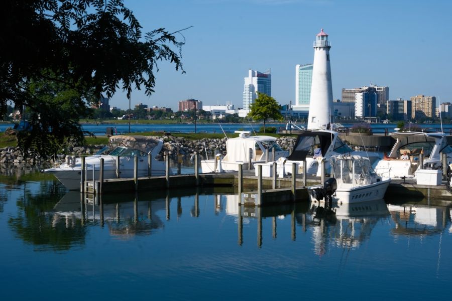 Boats docked at marina with lighthouse.