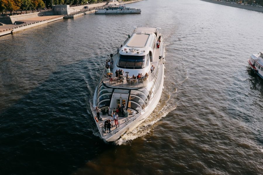 White sightseeing boat with passengers on river