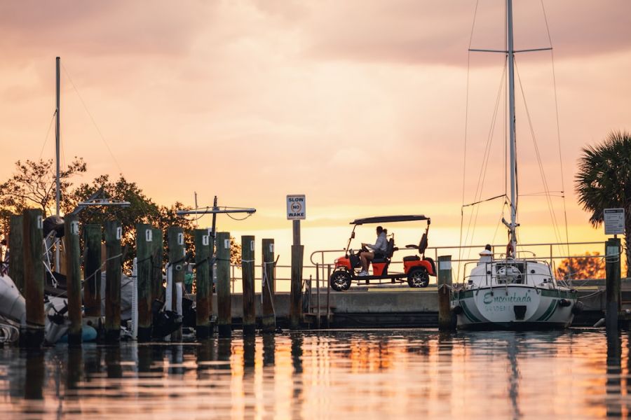 Sunset marina with boats and red cart