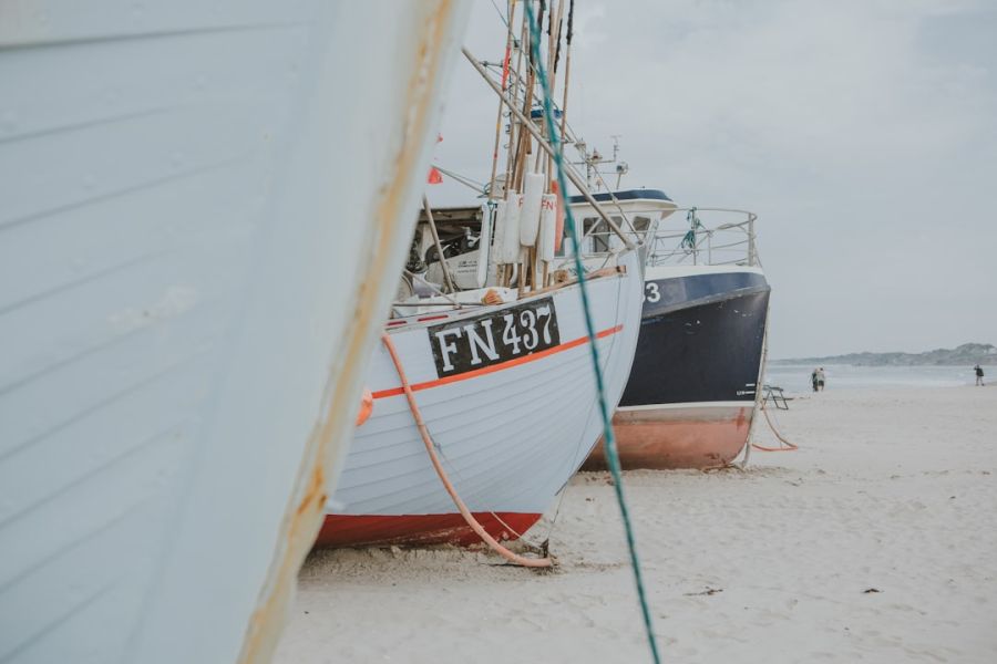 Beached fishing boats on a sandy shore.
