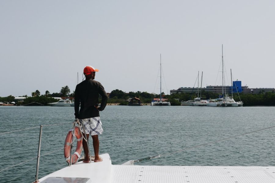 Man standing on boat overlooking harbor.
