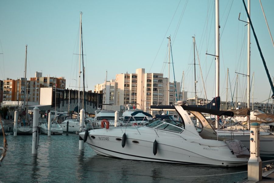 Yacht docked at marina with buildings