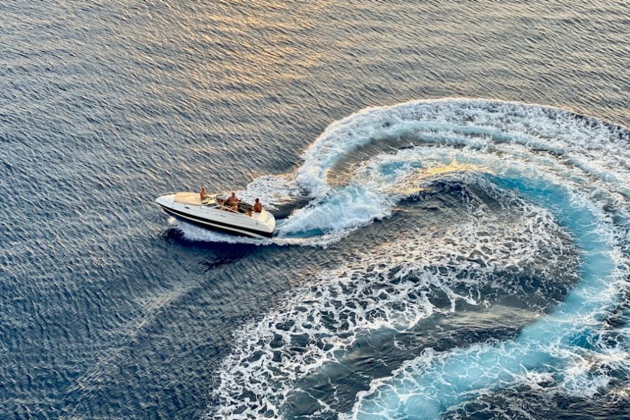 Speedboat carving circular turquoise wake.