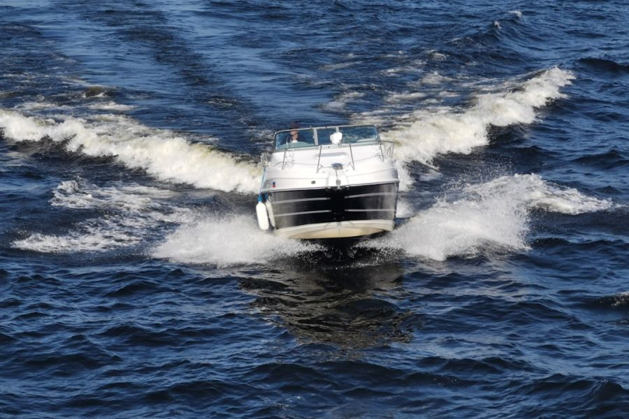 Sleek silver boat heads toward viewer