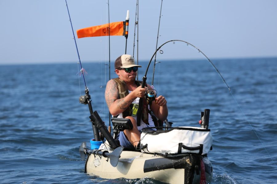 Man fishing from kayak in open sea