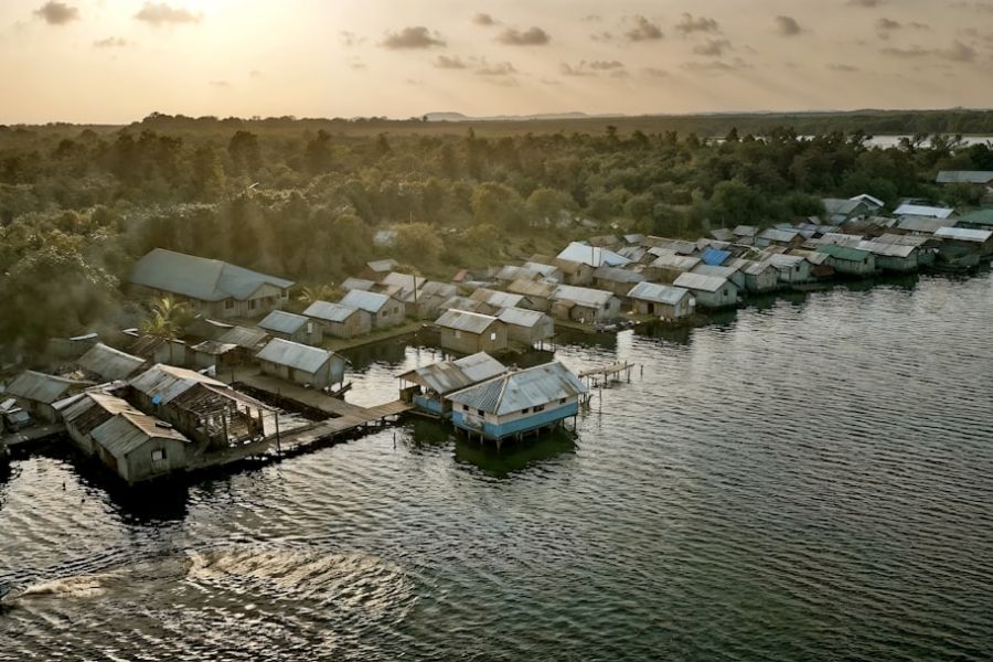 Waterfront stilt-house village at sunset.