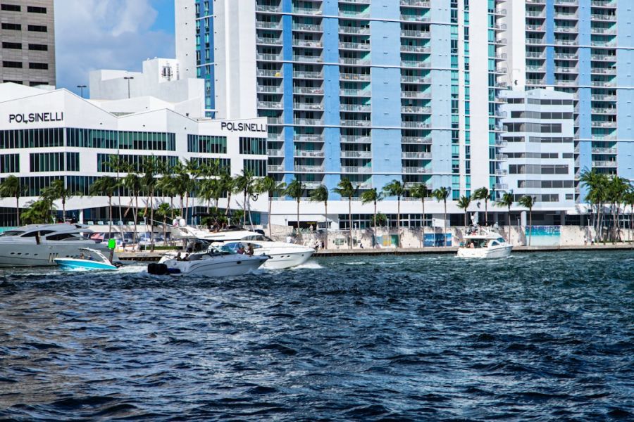 Boats near modern waterfront high-rise buildings