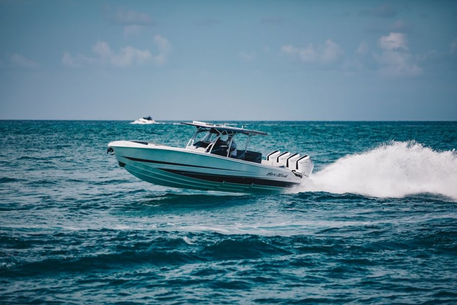 White speedboat glides on blue water
