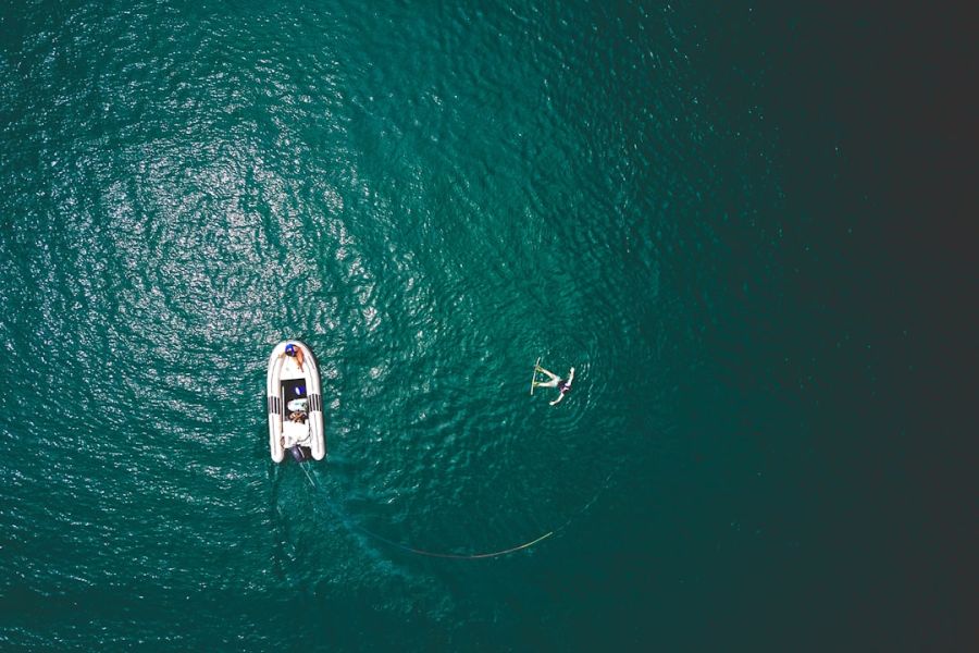 Aerial view of boat and paddleboarder