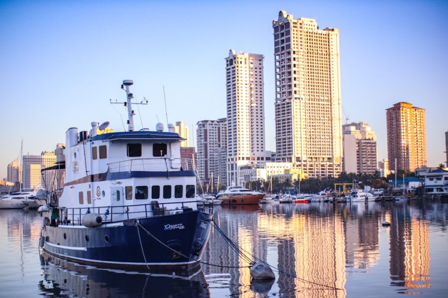 Boat docked at marina with city skyline