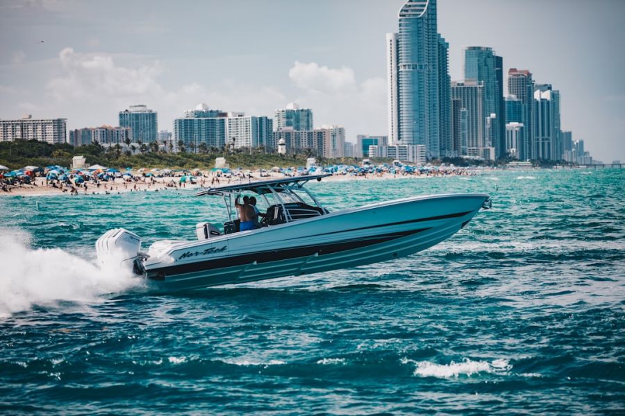 Speedboat speeding across turquoise water by city skyline