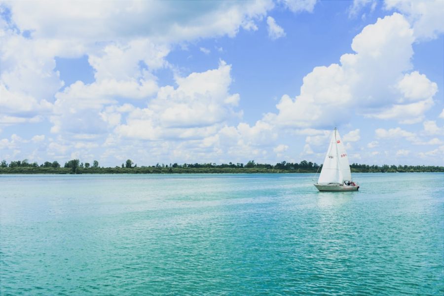 Sailboat on turquoise water under blue sky