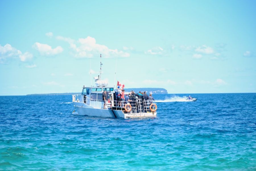 People on a white boat in blue ocean