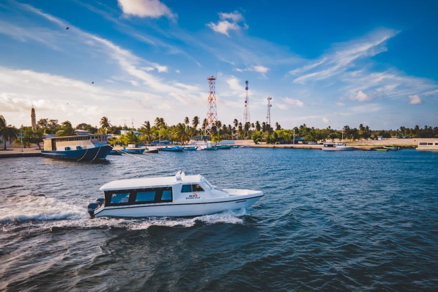 White speedboat cruising through blue harbor