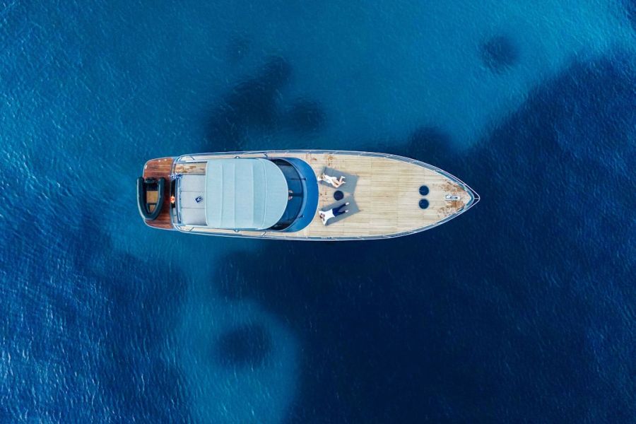 Aerial view of luxury yacht on blue water.