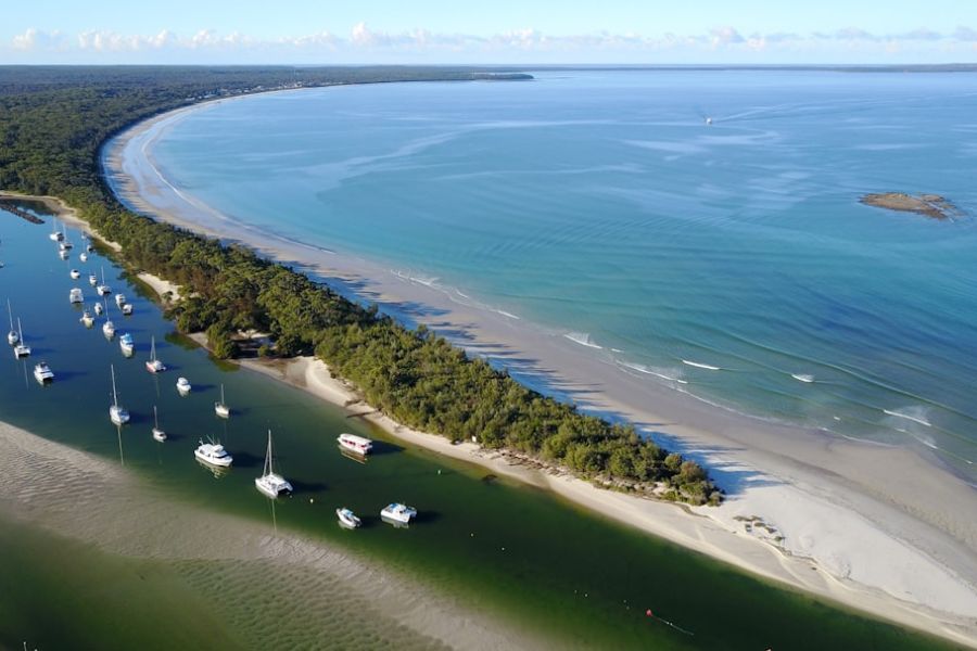 Aerial view of boats in coastal inlet.