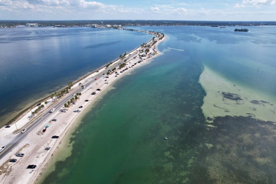 Aerial view of coastal highway along water.